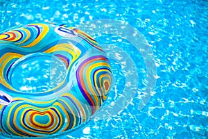 Inflatable colorful Rubber Ring floating in blue