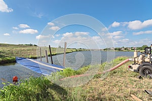 Inflatable dam flood barrier with industrial pump