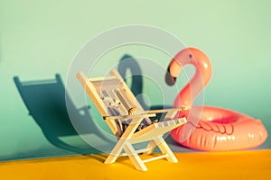 Inflatable Flamingo and deckchair on a blue background, pool float party