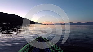 An Inflatable Kayak Gently Bobbing in Sea Bay at Dawn, Greece