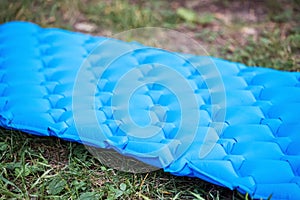 Inflatable mat for comfortable and warm sleep in a tent camping in nature. Reliable reflection of cold and protection from