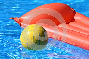 Inflatable mattress and ball in pool