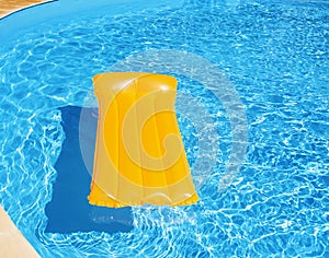 Inflatable mattress floating in the pool