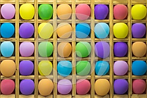 Inflatable multi-colored balls in wooden cells for playing darts, background