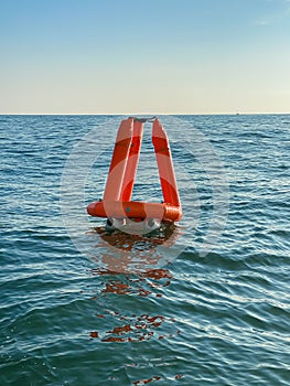 Inflatable orange buoys in a lake. Safety in a water.