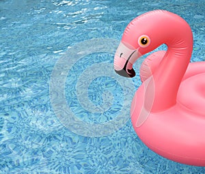 Inflatable pink flamingo float in bright blue pool water