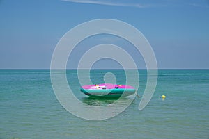 Inflatable ring or lilo in the sea by the beach