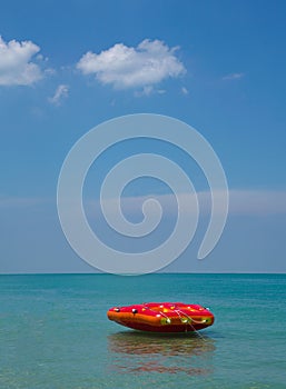 Inflatable ring or lilo in the sea by the beach