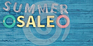 Inflatable ring and summer sale on blue wooden board 3D illustration.
