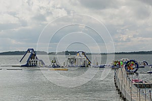 Inflatable slide bounce or water sliders at water park at bright day