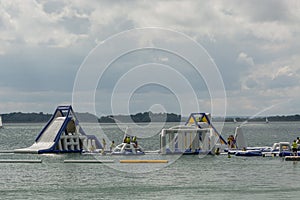 Inflatable slide bounce or water sliders at water park at bright day