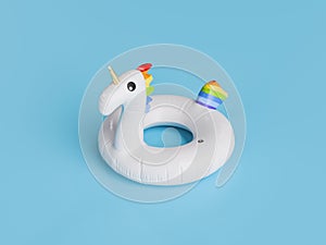 inflatable unicorn float on a blue studio background