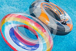 Inflatable water activities circles tuba float on the water in the pool. Concept, fun, perky summer and relaxation