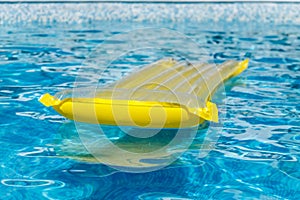 Inflatable water activities mattresses float on the water in the pool. Concept, cheerful, perky bright colorful summer and