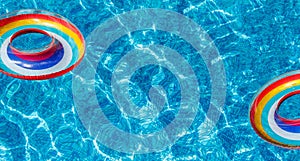 Inflatable water activities two circles tuba float on the water in the pool. banner.Concept, fun, perky summer and relaxation photo