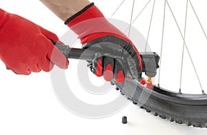 inflate a flat tire of a bicycle with a hand pump, close-up