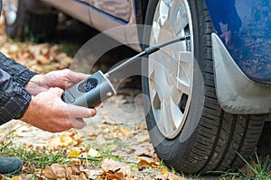 Inflating car tires with a portable wireless air pump outdoor