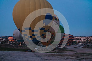 inflating hot air balloons at dawn