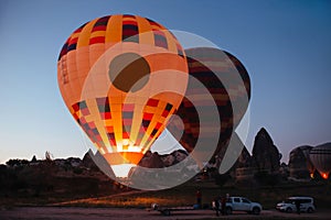 inflating hot air balloons at dawn