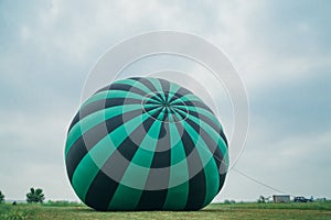Inflating, unpack and flying up hot air balloon watermelon. Burner directing flame into envelope. Take off aircraft fly