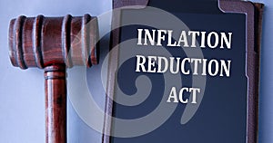 INFLATION REDUCTION ACT - words on an electronic notepad with a judge\'s gavel in the background photo