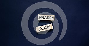 Inflation shocks symbol. Concept words Inflation shocks on wooden blocks. Beautiful black table black background. Business