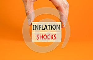 Inflation shocks symbol. Concept words Inflation shocks on wooden blocks. Beautiful orange table orange background. Businessman