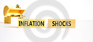 Inflation shocks symbol. Concept words Inflation shocks on wooden blocks. Beautiful white table white background. Wooden chest