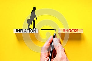 Inflation shocks symbol. Concept words Inflation shocks on wooden blocks. Beautiful yellow table yellow background. Businessman