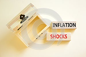 Inflation shocks symbol. Concept words Inflation shocks on wooden blocks. Beautiful white table white background. Empty wooden photo