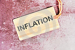 Inflation word written on a card with a rope on an abstract background