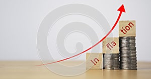 Inflation wording on coins tracking and up arrow for goods expensive to economy depression concept