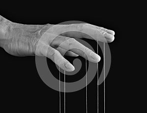 Influence, manipulation concept. Man hand with strings on fingers. Master, abuser using power to control person behavior