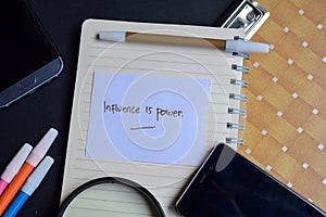 Influence is power word written on paper. influence is power text on workbook, technology business concept