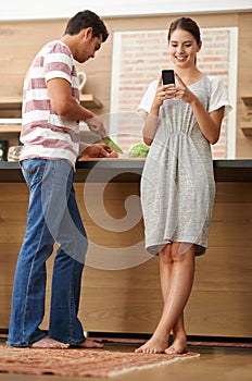 Influencer couple, vegetables and phone in kitchen for online content creation, ebook and nutrition in house. Man, woman