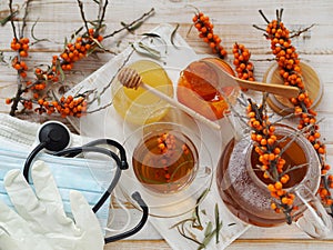 Influenza protection and treatment concept with folk remedies using healthy sea buckthorn berries.Protective medical mask with a