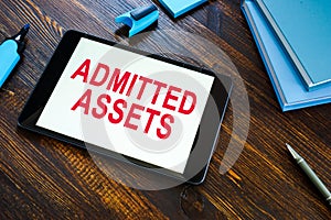 Info about admitted assets on the office desk. photo