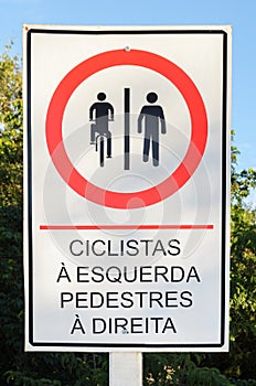 Info board in Portuguese signaling where cyclists and pedestrian photo