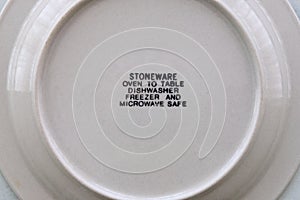 Info care label at the back of a ceramic plate.