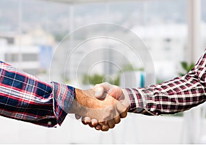 informal businessmen handshake in the office