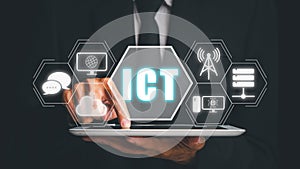 Information and Communications Technology ICT concept, Person hand typing keyboard computer on desk with ICT icon on virtual