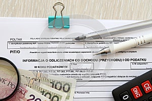 Information about deductions from income and tax, PIT-O form on accountant table with pen and polish zloty money bills