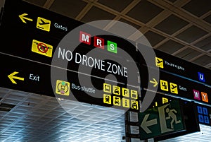 Information panel with No drone flying warning sign on it at an international airport.