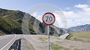 Information road sign speed limit within 70 kilometers per hour. A warning about the speed limit in the mountains. Safe journey
