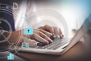 Information security. Man using laptop at table indoors, closeup