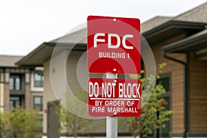 Information sign with inscription: FDC Building 1, do not block by order of fire marshal, trees and