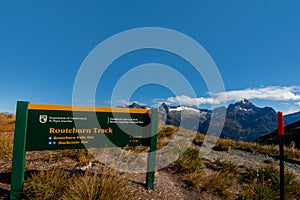 Information signpost at the Harris Saddle on Routeburn Track Great Walk, scenic view of Darran Mountains and Hollyford Valley