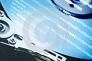 Information technology concept. Coding programmer language script text on hard disk drive. Programmer occupation job