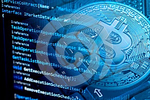 Information technology concept. Coding programmer language script text on screen monitor display with a PC keyboard and bitcoin