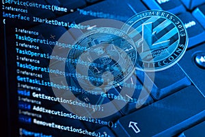 Information technology concept. Coding programmer language script text on screen monitor display with a PC keyboard and bitcoin,